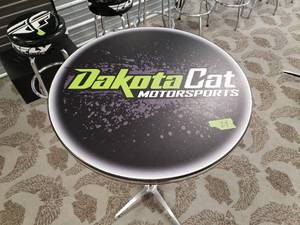 lot 24 image: Round High top Table with Dakota Cat Logo 43 inches high and 27 inches across