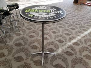 lot 25 image: Round High top Table with Dakota Cat Logo 43 inches high and 27 inches across