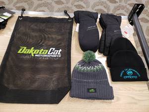 lot 174 image: Lot of Artic Cat gloves, mittens, 3 hats and a Dakota Cat Bag