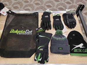 lot 175 image: Lot of Artic Cat gloves,  hats and a Dakota Cat Bag