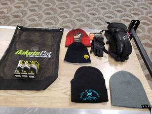 lot 179 image: Lot of gloves,  hats, and a Dakota Cat Bag