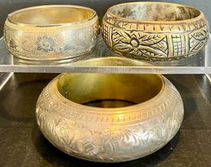 lot 53 image: Set of 3 Ornate Vintage Metal Bangles with Floral and Geometric Designs