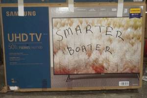 lot 112 image: Samsun 50 UHD TV, powers up. Barely used. With remote
