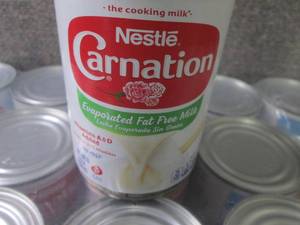 lot 225 image: 24- 12 oz Nestle Carnation Evaporat...