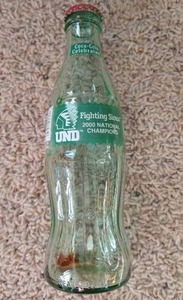 lot 29 image: 2000 UND Sioux Hockey Champions Coke Bottle