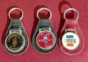 lot 169 image: (3) Vintage Automobile Keychains - Oldsmobile, Pontiac, Camaro