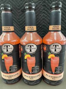 lot 30 image: Set of 3 Mr & Mrs T Peach Bellini Mix Bottles 1L Each