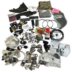 lot 58 image: Huge Chevy NOVA Car Parts and Accessories - Carpet Guard, Distributor Vacuum, Headlamp Retaining Rings, Trunk Mount Trouble Light, New Fox Shox 803-23-223-A Shock Rebuilding Kits, and More