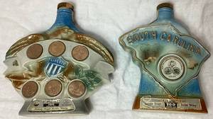 lot 24 image: 1970 Liberty Bell Jim Beam Whiskey Decanter and 1970 South Carolina Dispensary Tricentennial 1670-1970 Decanter