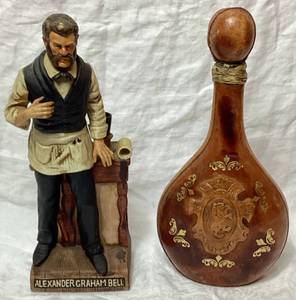 lot 41 image: 1977 Alexander Graham Bell McCormick Whiskey Decanter and Vintage Leather Wrapped Liquor Bottle with Lion Head made in Italy