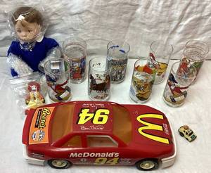 lot 83 image: McDonalds Collection of Glasses, Race Car and McMemories You Deserve A Break Today Doll