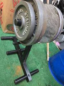 lot 42 image: Lot of 190 LB of 2 weight Plates (Four 35Lb and Two 25Lb) plus a Storage rack