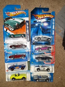 lot 308 image: Hot Wheels sports Shelby Cobra 427 sc. 2 cards rough. As shown.