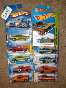 lot 324 image: Hot Wheels muscle car Dodge Plymouth Cuda Chagrer. One wrinkled card. As shown.