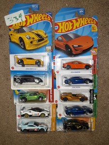 lot 334 image: Hot Wheels import lot. Lotus, Tesla, Bentley, Rivac Megane. One bad card. As shown.