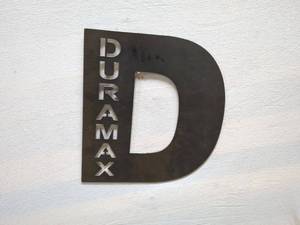 lot 35 image: Duramax Metal Sign Featuring Unique Lettering