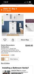 lot 9 image: Home Decorators Collection Doveton 24 in. Single Sink Freestanding White Bath Vanity with White Engineered Marble Top (Marble Top is Broken, but the base is intact