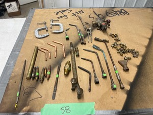 lot 58 image: TABLE FULL OF TORCH TIPS
