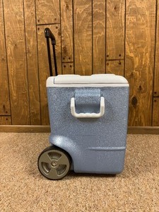 lot 109A image: Like New Blue Rubbermaid Large Cooler with Rollers