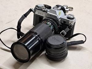 lot 94 image: Vintage Canon AE1 35mm Film Camera with 100-200mm Zoom Lens and Macro Lens