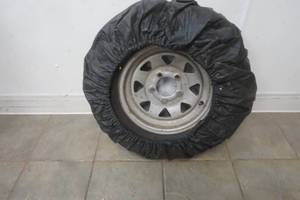 lot 173 image: spare tire and cover 5 bolt pattern ST17580R13. Trailer tire. Carlisle