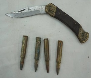 lot 186 image: folding knife and four 30-06 ammo