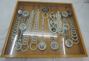 lot 242 image: Display cabinet Antique Spreader rings for horse harnesses