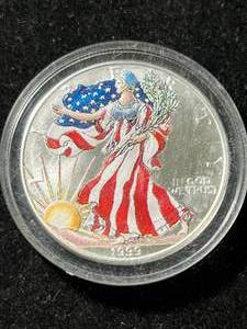 lot 17 image: 1999 AMERICAN SILVER EAGLE IN COLOR 1 TROY OZ .999 FINE SILVER