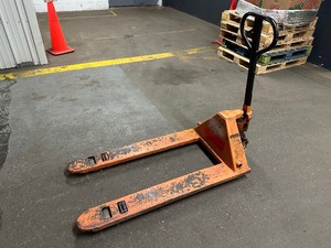 lot 448 image: Orange Pallet Jack - Works Good - Leaks Some Oil