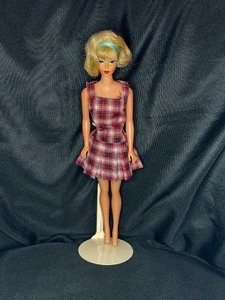 lot 26 image: VINTAGE BLONDE BARBIE WITH STAND WEARING PLAID DRESS