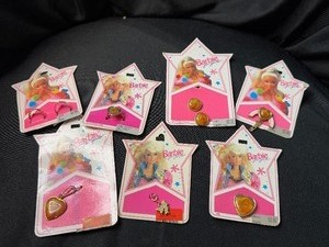 lot 149 image: LOT OF BARBIE CHARMS AND RINGS ON ORIGINAL PACKAGE