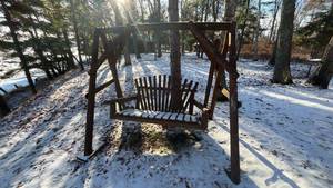 lot 43 image: Outdoor Wooden Swing Bench with Slatted Design