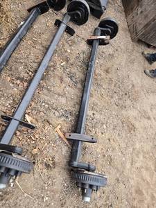 lot 27 image: One Heavy-Duty Trailer Axle with Electric Brakes - Model 76314F10D8EZ - Hub Face 93, Outside of Bracket 63.25,