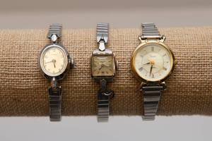 lot 123 image: Three Silver Tone Watches. 14K Gold Back of Watch Face