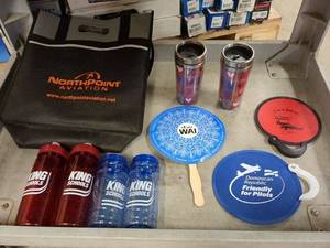 lot 180 image: Mixed Set of Promotional Items Featuring Water Bottles, Coasters, and a Tote Bag