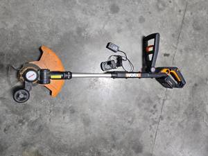 lot 143 image: Worx 20V Max Lithium Cordless String Trimmer with Charger