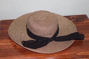 lot 219 image: Vintage Wide-Brimmed Straw Hat with Black Ribbon