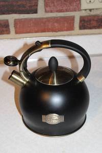 lot 421 image: Vintage Susteas Black Whistling Tea Kettle with Brass Accents