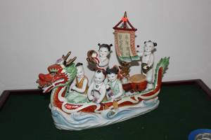 lot 38 image: Porcelain Dragon Boat Figurine with Five Children
