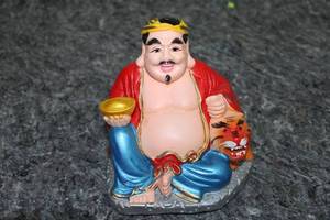 lot 84 image: Colorful Laughing Buddha Figurine with Tiger Detail