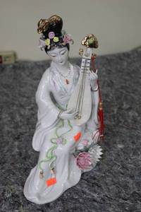 lot 91 image: Chinese Porcelain Figurine of Immortal Musician with Floral Accents