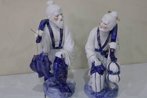 lot 98 image: Pair of Blue and White Porcelain Fisherman Figurines