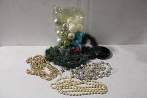 lot 492 image: Lot of Christmas Decorations including Ornaments, Beaded Garlands, Green Foliage, and Black Dish