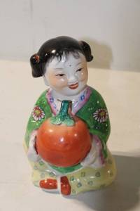 lot 497 image: Vintage Porcelain Figurine of a Girl Holding a Persimmon