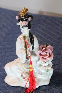 lot 513 image: Vintage Porcelain Lady Figurine Playing a Flute with Floral Accents