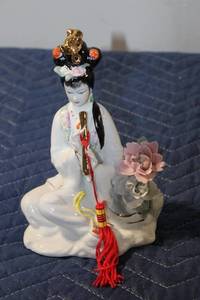 lot 516 image: Elegant Porcelain Figurine of Woman Playing Flute with Floral Accents