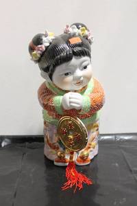 lot 562 image: Ceramic Oriental Figurine of Joyful Girl Holding Gold Coin