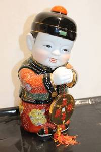 lot 563 image: Chinese Porcelain Figure of a Child Holding a Coin, 11 inches Tall