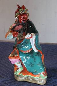 lot 573 image: Colorful Chinese Porcelain Figurine of a Deity Holding Dice