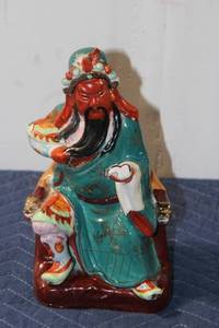lot 722 image: Vintage Hand-Painted Porcelain Figurine of a Seated Warrior